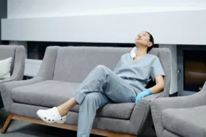 tired female surgeon sleeping on couch