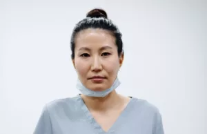 tired female surgeon standing
