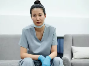 tired female surgeon getting off couch