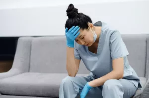 tired female surgeon worried on couch