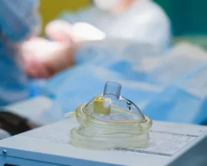 anesthesia mask in operating room with doctors and patient 