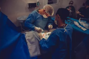 ongoing surgery with multiple doctors with masks