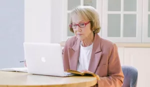 elderly surgery patient signing into virtual care in kitchen