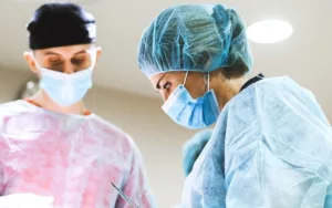 surgeon with assistant performing surgery in OR 