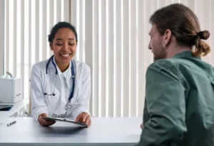 A surgeon explaining a procedure with a smiling patient 