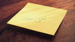 sticky-note with sorry and smiley face