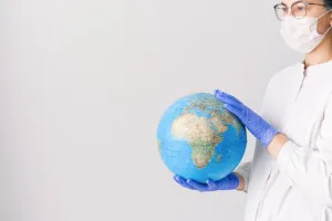 doctor with mask holding globe in a pandemic 