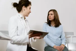 surgeon talking to patient with clipboard